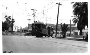 On 11th Street showing clearance between curb at southwest corner and street car making turn at Hoover Street, Los Angeles, 1928