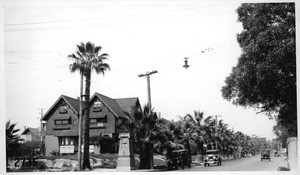 Looking northwest at Hoover and 11th Streets showing ornamental tract monument obstructing vision through northwest corner, Los Angeles, 1927