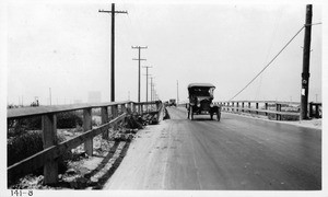 Bridge over the L.A. River on Anaheim Road near west city limits of Long Beach, showing exposed thal rail restricting travelable width of bridge and also setting up a serious menace to vehicular traffic, Los Angeles County, 1922