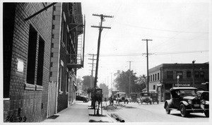 Looking south on Hoover Street across Venice Boulevard showing roadway restricted 20% on account of L.A. Gas Company's excavation, Los Angeles, 1926