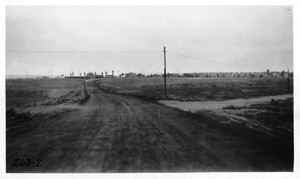 Photograph showing oil treated road leading from Redondo-Wilmington Boulevard at south city limits to Redondo to the north shore entrance of the Palos Verdes estate, Los Angeles, 1925