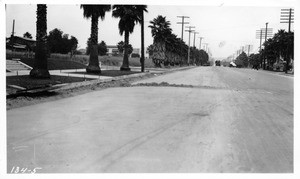 Cross excavation on Sunset Boulevard near Harvard Street showing high fill over cross trench, as well as the longitudinal trench at Harvard, Los Angeles, 1922