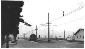 Looking westerly on Santa Barbara Avenue at 3rd Avenue showing Los Angeles Railway crossing and two way roadway 18 1/2 feet wide, Los Angeles, 1929