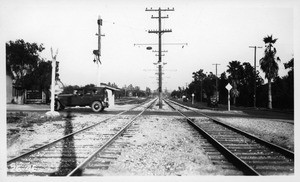 Looking east along center line of P.E. tracks on Huntington Drive from west side of Rose Avenue, showing the north roadway of Huntington Drive east of Rose Avenue to be a dirt lane not used by automobiles, Los Angeles County, 1926