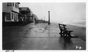 Looking south from end of Ocean Walk at 34th Street, Hermosa Beach, showing concrete walk undermined and cracked by heavy surf, Los Angeles County, 1940