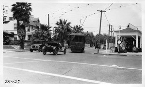 On 11th Street opposite Park View Street looking northwesterly across Hoover Street showing limited clearance for automobiles between curb and street car making turn, Los Angeles, 1928