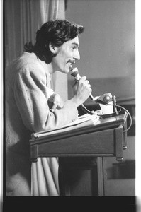 Alejandro Murguía speaking at a lecturn, Los Angeles, 1973