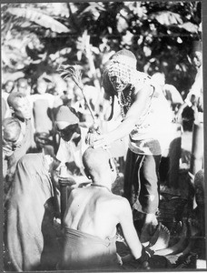 Sorcerer treating a sick person, Tanzania, ca.1913-1938