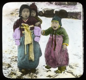 Three Korean children standing in the snow, Korea, ca. 1920-1940