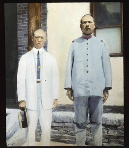 Two Chinese men standing on the steps of a building, Hunan, China, ca.1917-1923