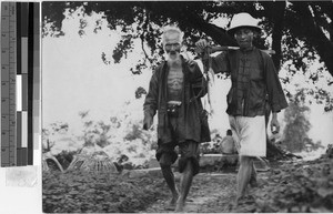 Two men and fish, Hong Kong, China, ca. 1930