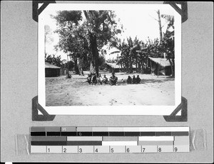 A group of people sitting under a tree, Nyasa, Tanzania, 1936