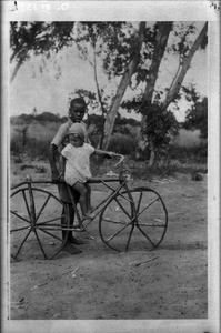 Children with a bicycle made out of wood, southern Africa