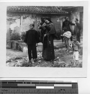 Maryknoll Sister visiting people in a village at Meixien, China, 1936