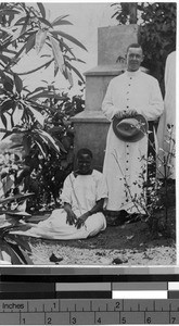 Priest and woman by a stone pillar, Uganda, Africa, October 1917