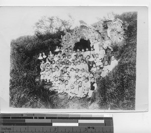 Sisters with orphans at a carved cave in China