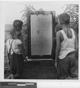 Children praying at a grave at Wuzhou, China, 1950