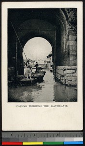 Boat going through arched gate, China, ca.1930-1940