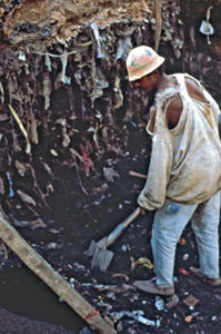 Mission at the bottom - City Mission in Madagascar. Plant bags create new jobs. This man is dig