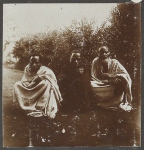 Three squatting African men, Tanzania