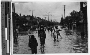 People walking in floodwaters, Peng Yang, Korea, ca. 1920-1940