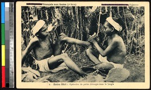 One child fixing something on another's foot, Rajasthan, India, ca.1920-1940