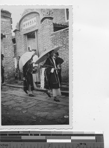 Mourners pass the mission at Luoding, China, 1937