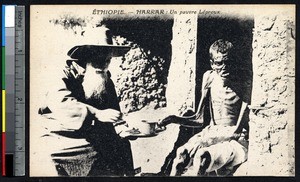 Missionary father serves a leprous man, Harer, Ethiopia, ca.1900-1930