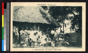 People assembling before a thatch-roofed building, Madagascar, ca.1920-1940