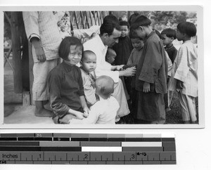 Maryknoll priest and children at Luoding, China, 1938