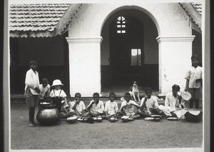 Boys of the orphanage taking a meal