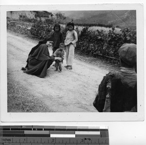 A Maryknoll Sister with children at Mexien, China, 1949