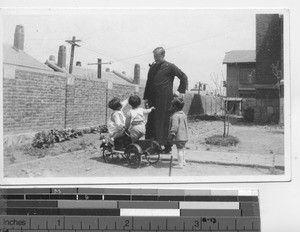 Maryknoll Father with kindergartners at Dalian, China, 1933