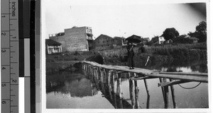 Girl standing on a bridge, Wuchow, China, May 1948