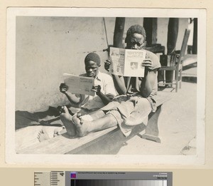 Patient and hospital worker reading, Mihecani, Mozambique, ca.1925