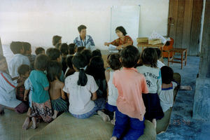 Beatrice and Chandara (interpreter) teaching Sunday School under Basalong's team house