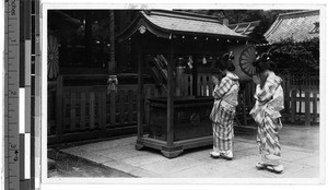 Two women worshiping at the Shinto shrine, Hikone, Japan, ca. 1920-1940