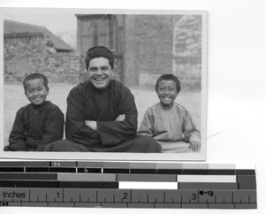 Fr. Leo W. Hewitt with two friends at Chagou, China, 1947