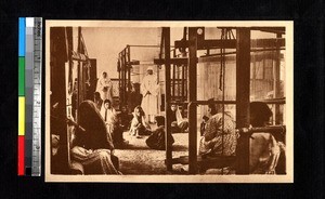 Missionaries standing with children working in a carpet-weaving mill, Ghardaïa, Algeria, ca.1920-1940