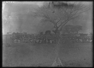 Swiss missionaries and African people sitting around a tree, Khovo, Maputo, Mozambique