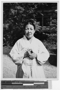 Portrait on an elderly Korean woman holding a rosary, Japan, ca. 1937