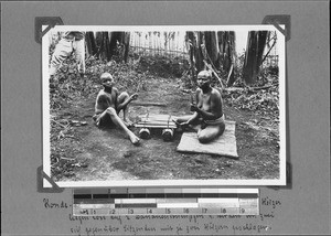 Konde mother and son playing an instrument, Nyasa, Tanzania, ca. 1891-1920