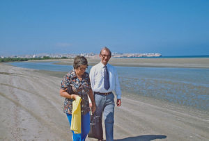 Bishop Thorkild Græsholt in conversation with missionary Martha Holst on the beach in Oman in 1