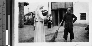 Maryknoll Sister and street sweeper, Guilin, China, ca. 1947