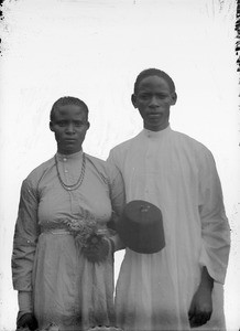 African couple with linked arms, Tanzania, ca.1893-1920