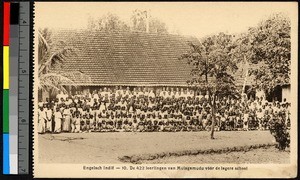 Large gathering of students drawn up outside a tile-roofed school, India, ca.1920-1940