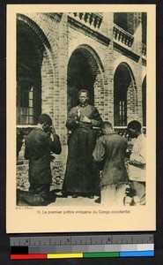 Indigenous priest blessing kneeling people, Congo, ca.1920-1940