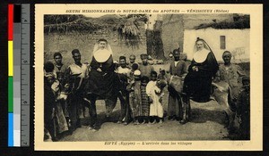 Missionary sisters on donkeys with assembled villagers, Egypt, ca.1920-1940