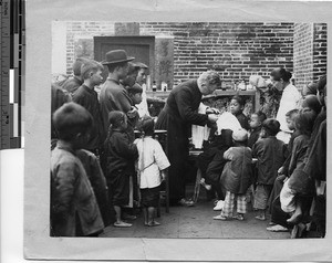 Reverend Robert J. Cairns, MM caring for patient at dispensary in Sun Chong, China, 1927