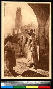 Three men near a mosque, Algeria, ca.1920-1940